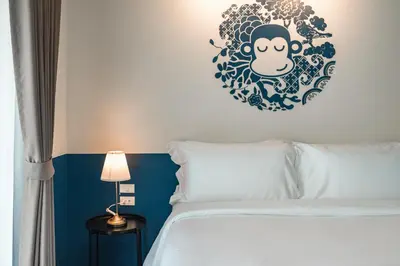 a bedroom with a bed with a sticker on the wall at Blu Monkey Boutique Naiharn - Serviced Apartments 1 Bedroom in Rawai Beach