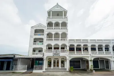 a white building with a clock tower at RQ Timeless Phuket Old Town in Phuket Town