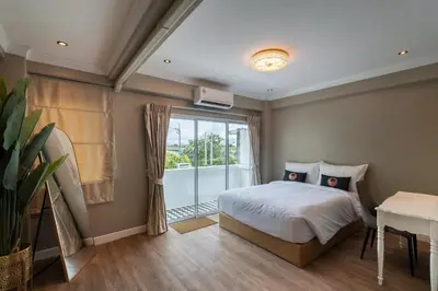 a bedroom with a bed and a window at RQ Timeless Phuket Old Town in Phuket Town
