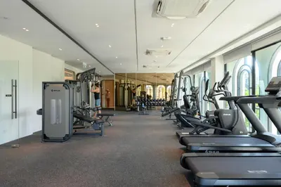 a gym with rows of treadmills and ellipticals at Bangtao The Title Legendary by Phuket Sabay Rent G402 in Bang Tao Beach
