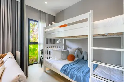 a bedroom with two bunk beds and a desk at Bangtao The Title Legendary by Phuket Sabay Rent C108 in Bang Tao Beach