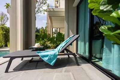 a chair sitting on top of a balcony at Bangtao The Title Legendary by Phuket Sabay Rent C108 in Bang Tao Beach