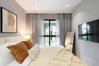 a bedroom with a white bed and a window at Bangtao The Title Legendary by Phuket Sabay Rent D204 in Bang Tao Beach