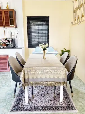 a dining room with a table and chairs at Sachi Home Bangtao -Private House Near Beach in Ban Thalat Choeng Thale