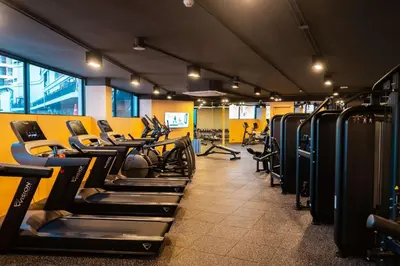 a gym with rows of treadmills and machines at Two Bedroom Sea View by Triple 8 Asia in Layan Beach