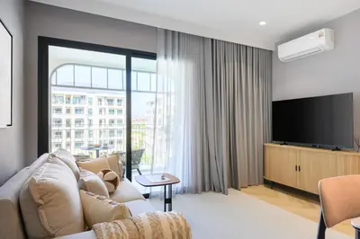 a living room with a couch and a flat screen tv at Bangtao The Title Legendary by Phuket Sabay Rent F501 in Bang Tao Beach
