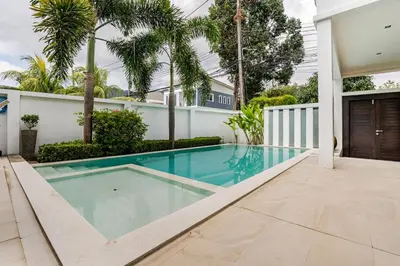 a swimming pool in the backyard of a house at Baan Araya by Villacarte in Ban Saiyuan (1)