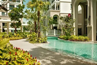 a swimming pool at a resort with palm trees and a building at Bangtao The Title Legendary by Phuket Sabay Rent F601 in Bang Tao Beach