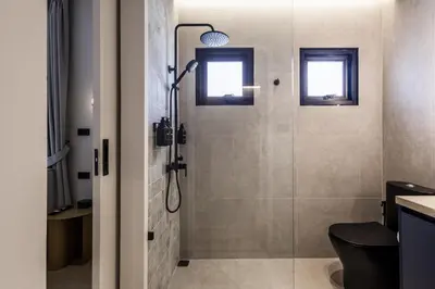 a bathroom with a shower with a toilet and a window at 5BR Luxury Pool Villa Patong TPSV138 in Patong Beach