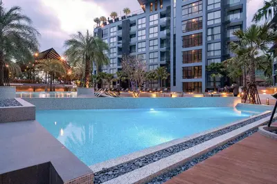 a large swimming pool in front of some buildings at 2 BR Apt Pool View - CTG B507-8 in Kamala Beach