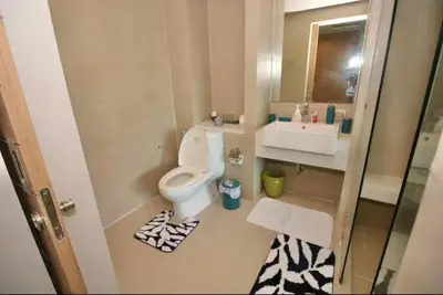 a small bathroom with a toilet and a sink at Pool and See View Amazing Room in Karon Beach