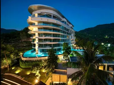 a large building with a swimming pool in front of it at Pool and See View Amazing Room in Karon Beach
