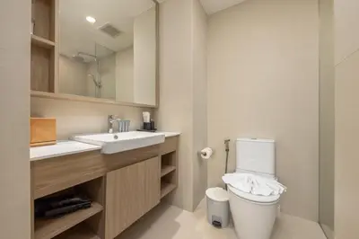 a bathroom with a toilet and a sink at Melia 2BR with Rooftop Pool - Skypark Laguna in Laguna Phuket