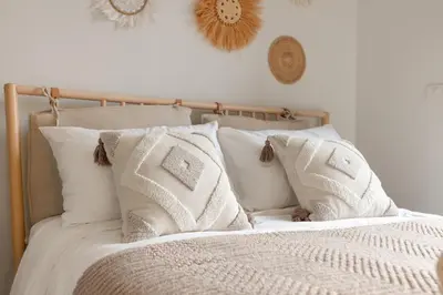 a bed with white blankets and pillows on it at Melia 2BR with Rooftop Pool - Skypark Laguna in Laguna Phuket
