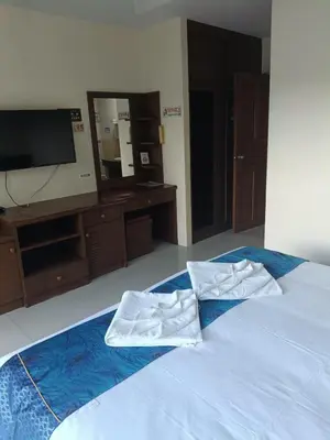 a bed with two white towels sitting on it at Hua LaiDe patong \u4e00\u5367\u5ba4\u5927\u5e8a\u623f in Patong Beach