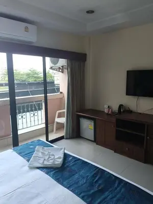 a bedroom with a bed with a television and a desk at Hua LaiDe patong \u4e00\u5367\u5ba4\u5927\u5e8a\u623f in Patong Beach