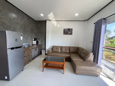 a living room with a couch and a refrigerator at 365 Place Maikhao in Ban Mai Salae