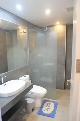 a bathroom with a toilet and a sink and a shower at Tower2 Condominium in Ban Klang