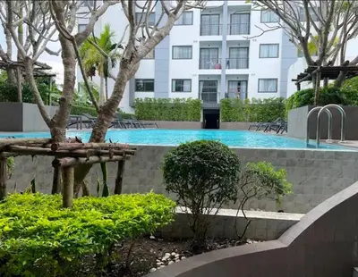 a swimming pool in a building with trees and bushes at Tower2 Condominium in Ban Klang