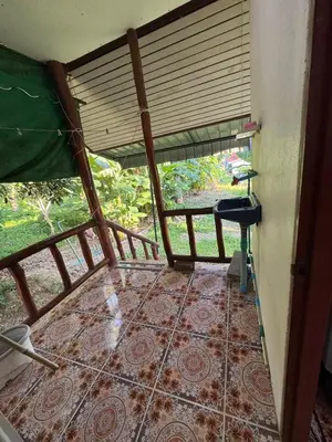 a room with a tiled floor with a window at Family house in Ban Laem Sai