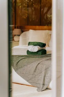 a bedroom with a bed with towels on it at Botanica Foresta B09 in Ban Phru Champa