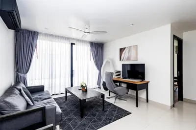 a living room with a couch and a desk at Villa Laguna Park in Ban Thalat Choeng Thale