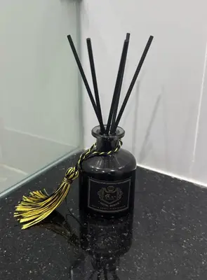 a black vase with sticks in it on a counter at Smily Phuket Patong Sea View in Patong Beach