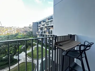 a balcony with a table and a chair on it at Cozy studio 1 bdr Golf view in Laguna Phuket