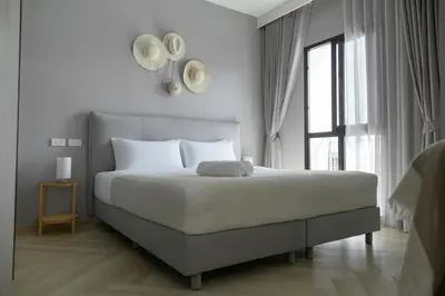 a bedroom with a large white bed with a window at The Legendary Bang Tao 1-bedroom apart #711 in Bang Tao Beach