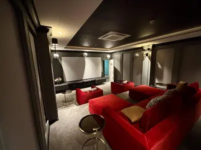 a living room with a red couch and a screen at The Legendary Bang Tao 1-bedroom apart #711 in Bang Tao Beach