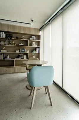 a dining room with a table and a blue chair at The SPACE Apartment 612 in Ban Thalat Choeng Thale