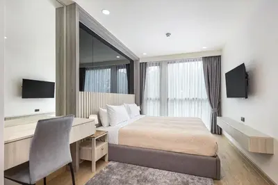 a hotel room with a bed and a desk and a desk at Ozone condominium Bang Tao by My Home Phuket in Laguna Phuket