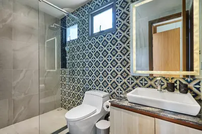 a bathroom with a toilet and a sink and a mirror at Villa the Ozone Bang Tao by My Home Phuket in Laguna Phuket