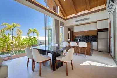 an open kitchen and dining room with a table and chairs at Villa the Ozone Bang Tao by My Home Phuket in Laguna Phuket