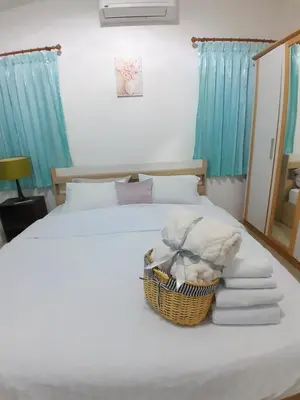 a bedroom with a bed with a basket on it at Baan Saun PK in Ban Bang La