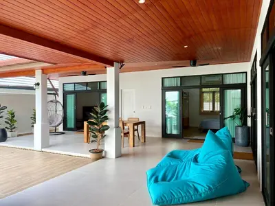 an open living room with a wooden ceiling at Baanthai villa Rawai in Rawai Beach