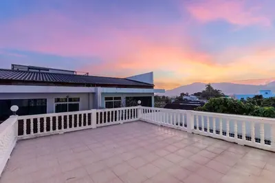 a balcony of a house with a sunset at V274 Prime Location Large Terrace Pool View BBQ in Ban Saiyuan (1)