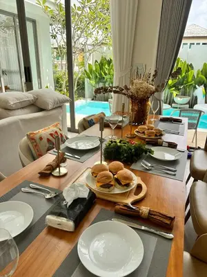 a dining room table with plates of food on it at Pride luxury house in Koh Lone