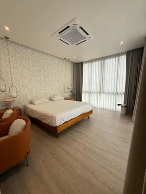 a bedroom with a bed and a couch at Pride luxury house in Koh Lone