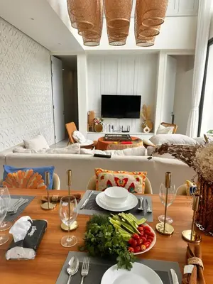 a dining room with a table with vegetables on it at Pride luxury house in Koh Lone