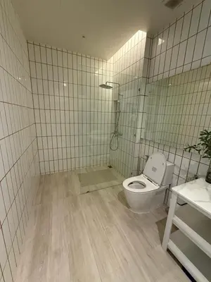 a tiled bathroom with a toilet and a shower at Pride luxury house in Koh Lone