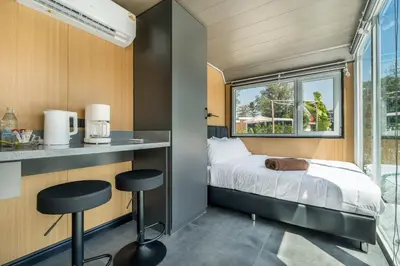 a small bedroom with a bed and a window at Apple House 1 Min Walk to Bang Tao Beach in Ban Lum Fuang