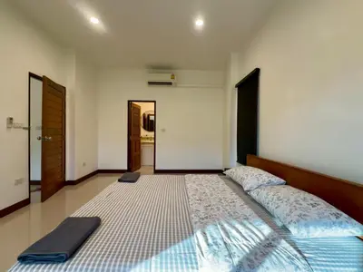 a bedroom with a large bed in a room at Sea sand Bungalow in Phuket Town