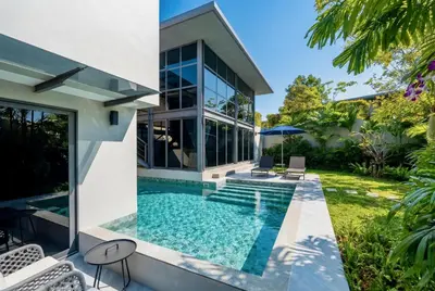 a swimming pool in the backyard of a house at RIVERHOUSE Solar-Powered Luxury Pool Villas in Laguna Phuket