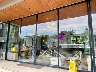 a man standing in front of a store window at Diamond Resort 1 Bdr Bang Tao in Bang Tao Beach