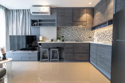 a kitchen with wooden cabinets and a counter top at Comfortable 1 bdr Kamala City Gate in Kamala Beach