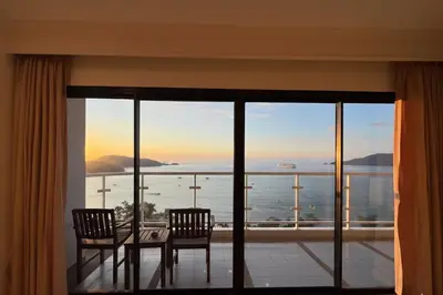 a dining room with a view of the ocean at Highest Apartment in Phuket Panaromic Seaview in Patong Beach