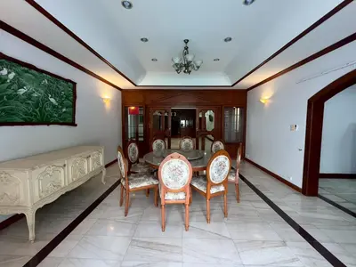 a dining room with a table and chairs at Villa Vasu in Ban Bang Khu