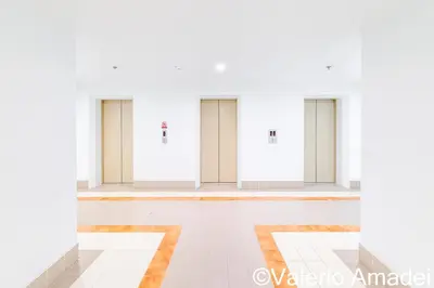 a row of doors in a white room at OMNIAPhuket - Sea View Patong Tower 100m to Beach in Patong Beach