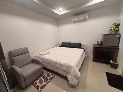 a bedroom with a bed and a chair at Mong Do Lay Baan Sea View in Ban Ao Makham